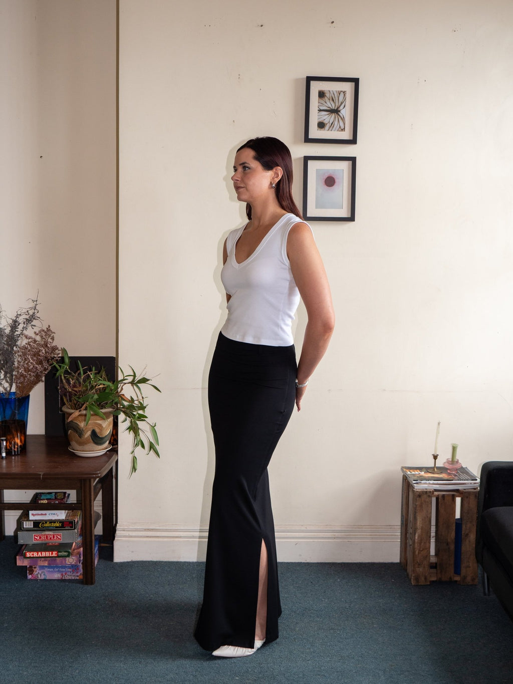 Side view of long pencil skirt with side split, black